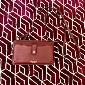 Crossbody bag color is black raspberry